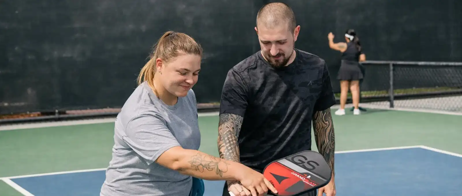 A coach and a player in a private pickleball lesson